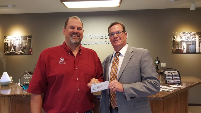Spencer Area Jobs Trust President Ryan Johnson presents a check to Donavan Wunschel with Midwestern Mechanical, Inc. for the company’s participation in the organization’s Internship Program.
