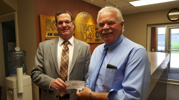 Spencer Area Jobs Trust President Ryan Johnson presents a check to Dave Putnam of Spencer Radio Group for the business’s participation in the organization’s Internship Program.